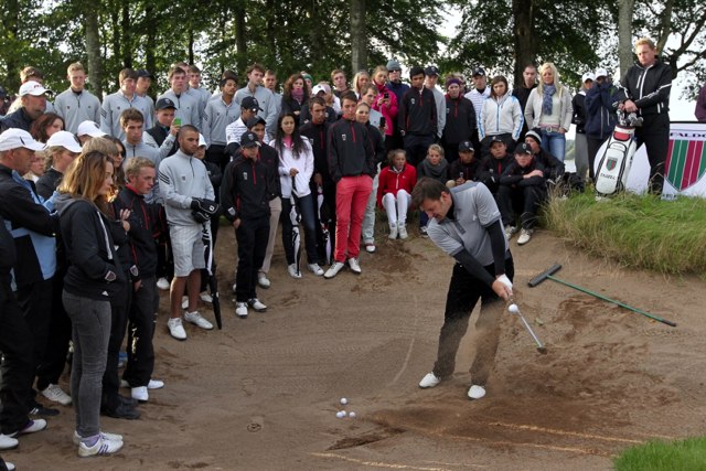 Sir Nick Faldo giving a short game clinic to competitors during the 16th Faldo Series Grand Fina